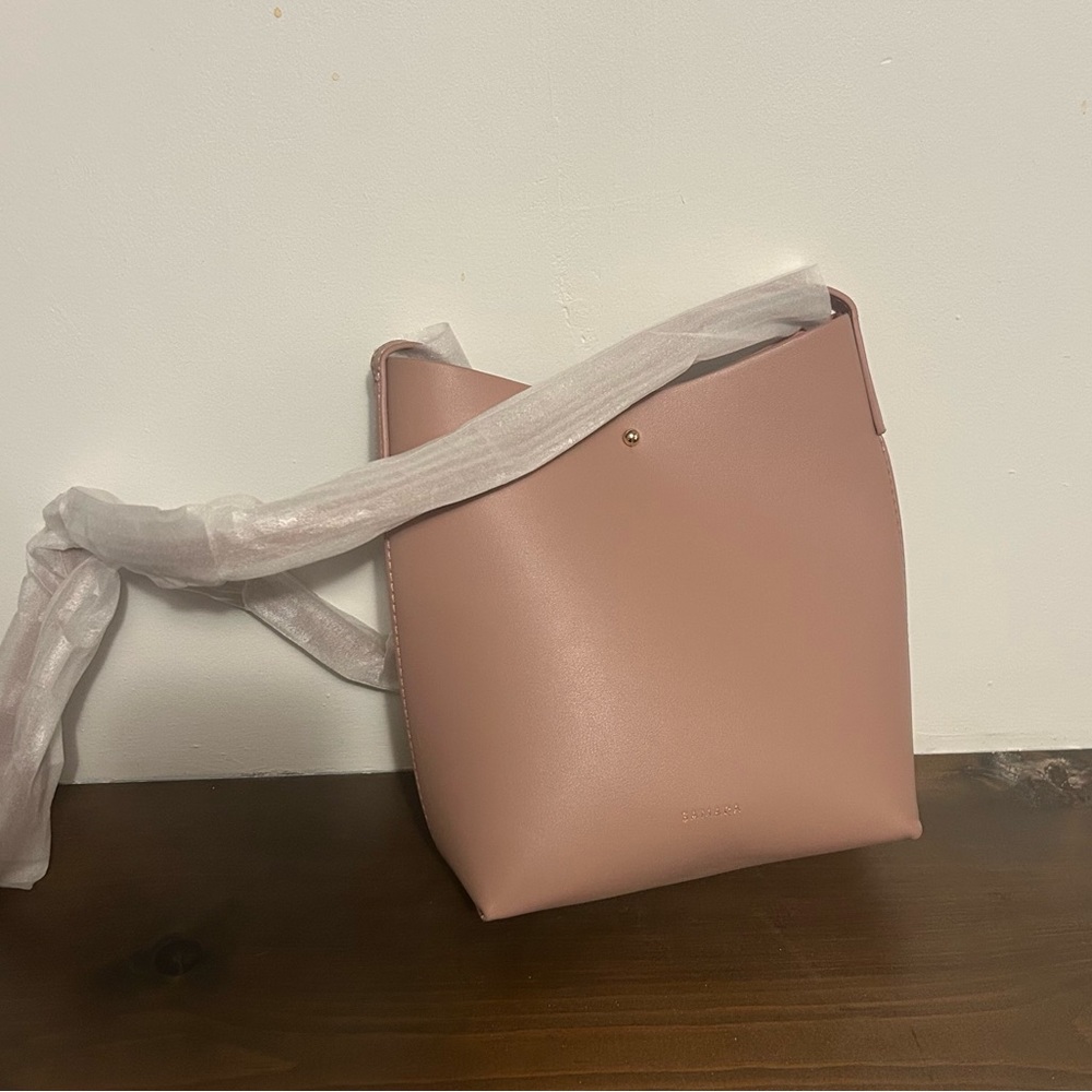 Samara light pink crossbody. Never used. Still has wrapping on strap.
